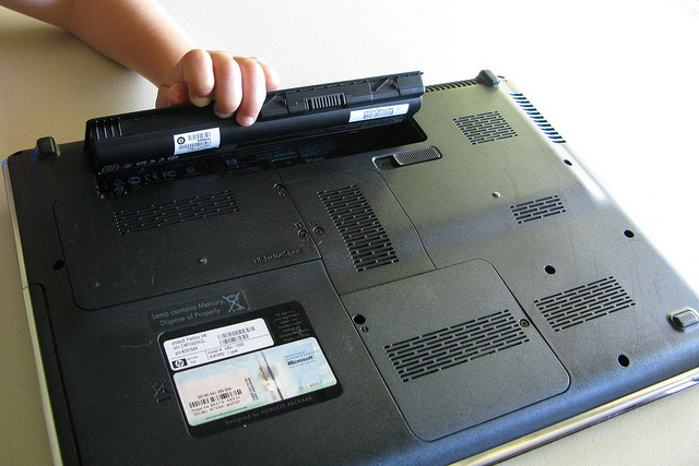 Barn, der fjerner laptopbatteri